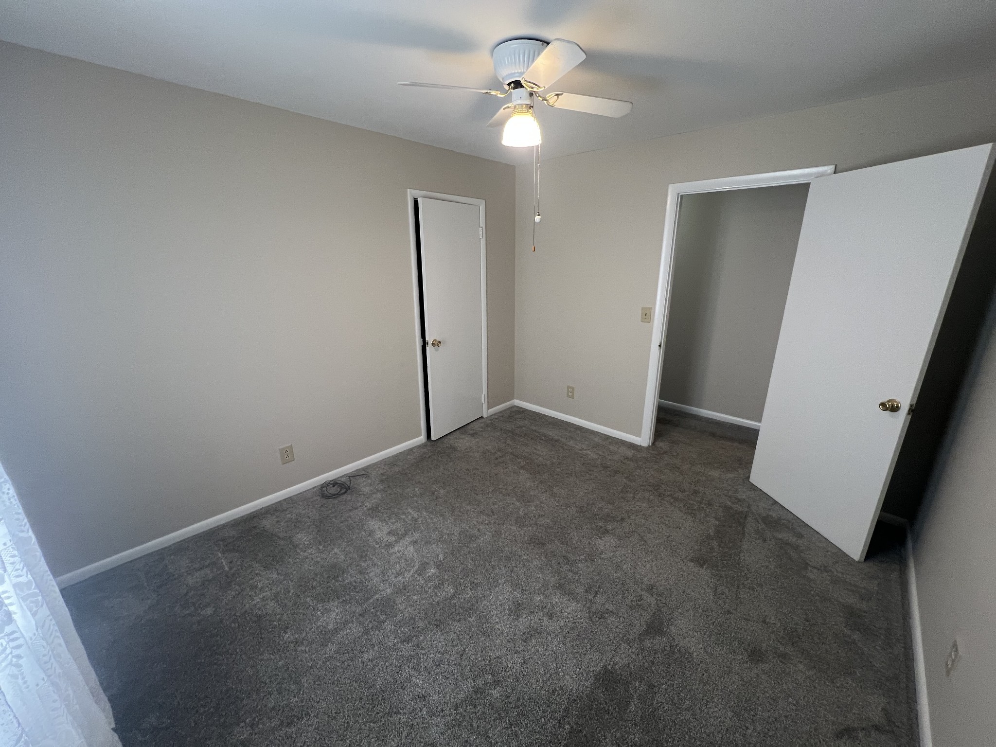 220 Apache Circle Pulaski, TN 38478 - Photo 18 of 25 an empty room with windows and fan
