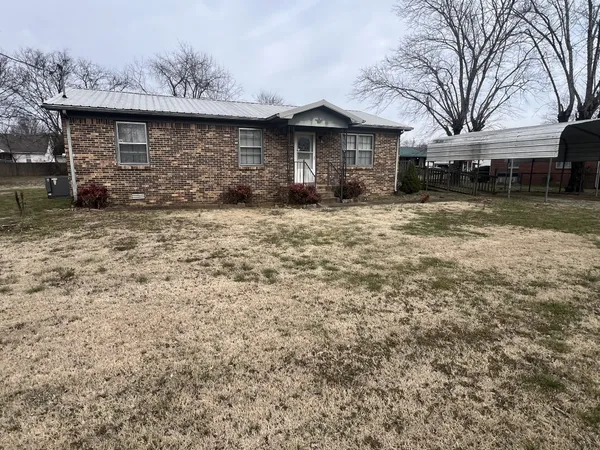 a front view of a house with parking space