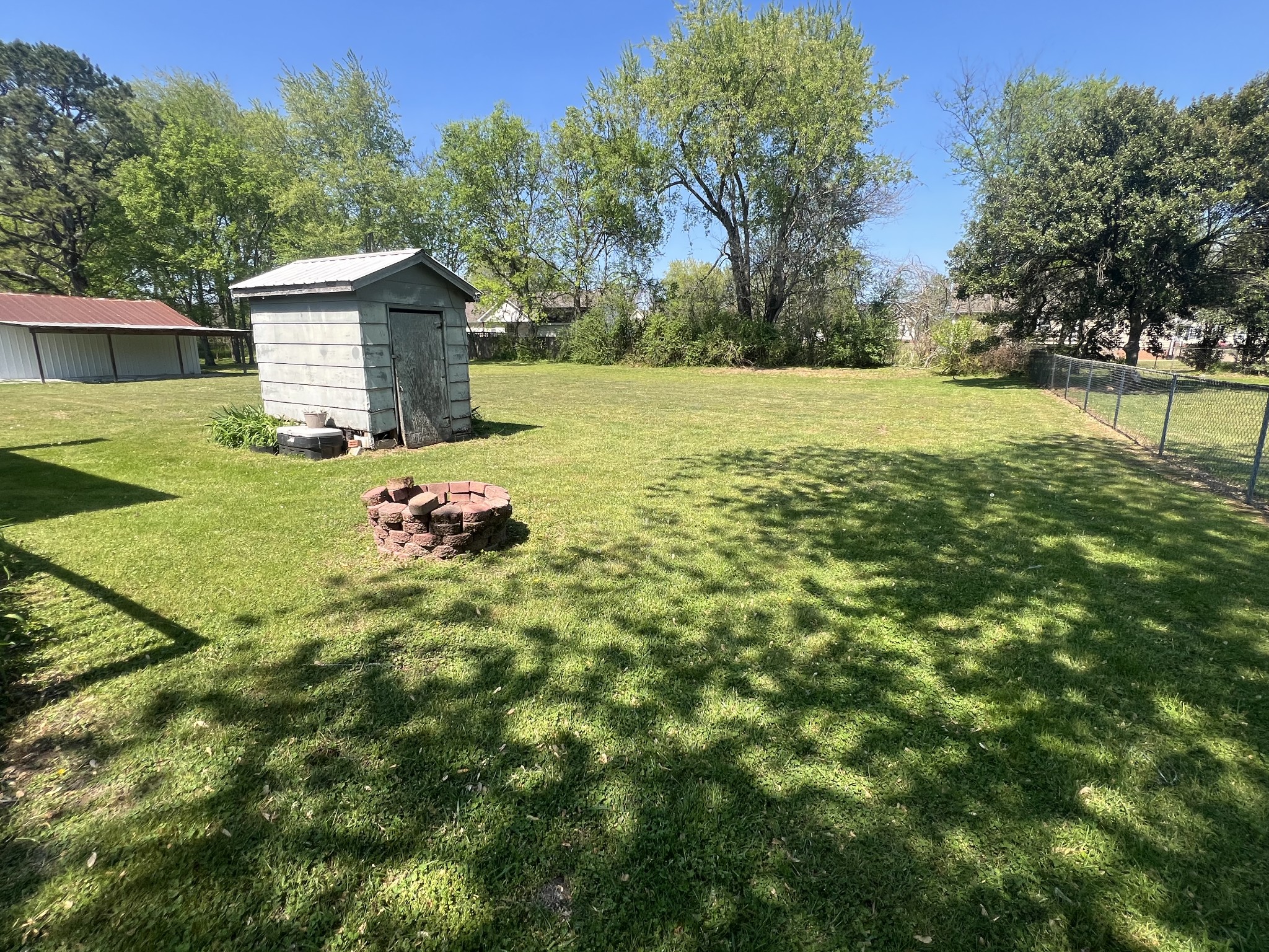 220 Apache Circle Pulaski, TN 38478 - Photo 24 of 25 a backyard of a house with table and chairs plants and large tree