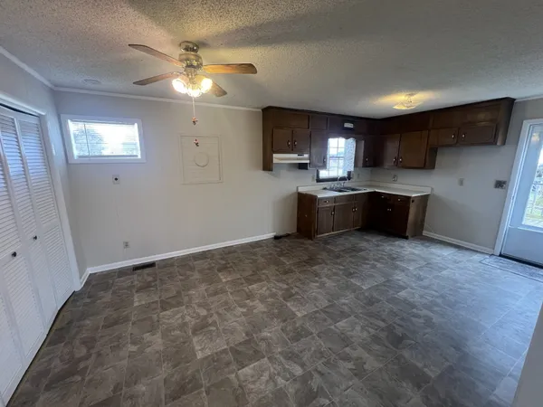 a large kitchen with kitchen island a stove a sink dishwasher and a refrigerator