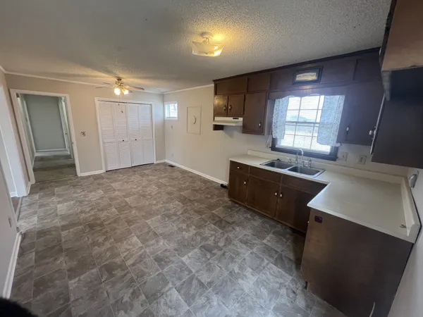 a large kitchen with a sink a stove and a refrigerator