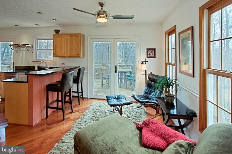 1874 Post Oak Trail Reston, VA 20191 - Photo 2 of 30 a living room with furniture potted plant wooden floor and a large window