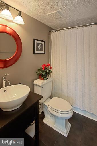 1874 Post Oak Trail Reston, VA 20191 - Photo 11 of 30 a bathroom with a sink a toilet and a mirror
