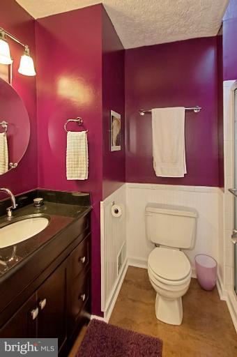 1874 Post Oak Trail Reston, VA 20191 - Photo 17 of 30 a bathroom with a granite countertop toilet sink and mirror