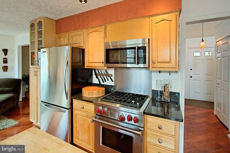 1874 Post Oak Trail Reston, VA 20191 - Photo 21 of 30 a kitchen with stainless steel appliances granite countertop a refrigerator stove and sink