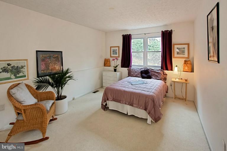 1874 Post Oak Trail Reston, VA 20191 - Photo 22 of 30 a bedroom with a bed chair and window