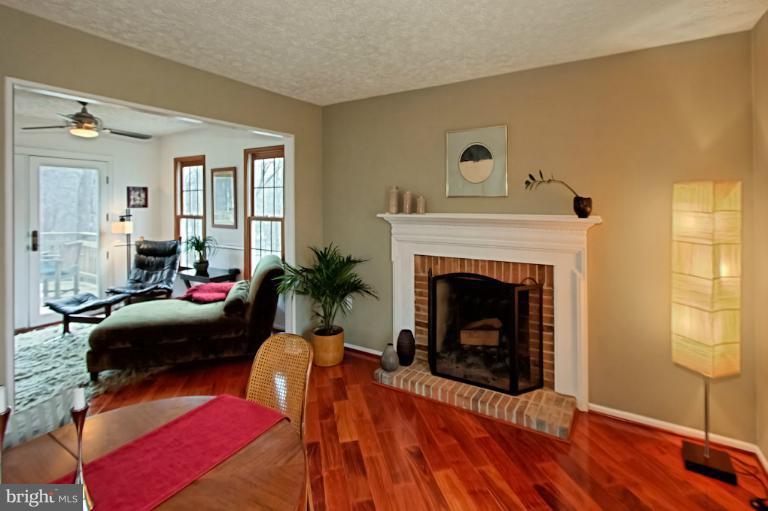 1874 Post Oak Trail Reston, VA 20191 - Photo 24 of 30 a living room with furniture and a fireplace