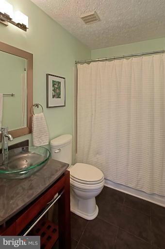 1874 Post Oak Trail Reston, VA 20191 - Photo 6 of 30 a bathroom with a sink toilet and a mirror