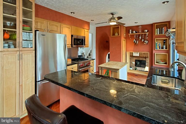 1874 Post Oak Trail Reston, VA 20191 - Photo 7 of 30 a living room with stainless steel appliances kitchen island granite countertop a table chairs and a large window