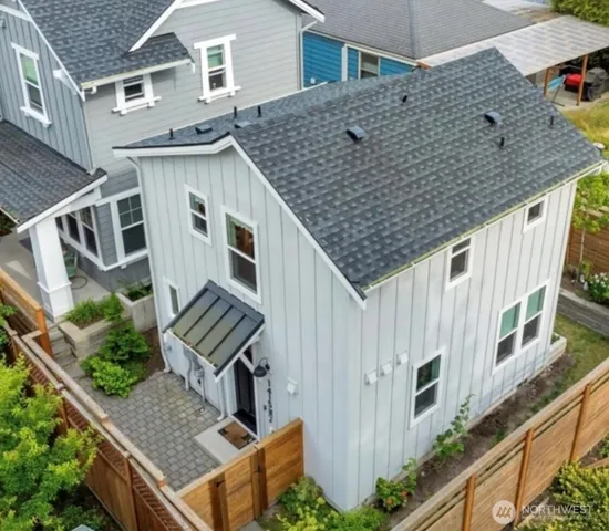 an aerial view of a house with a yard and potted plants