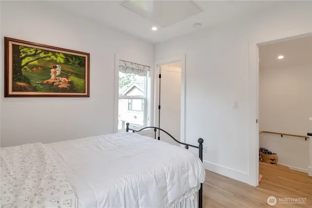 a bedroom with a bed and a painting on the wall