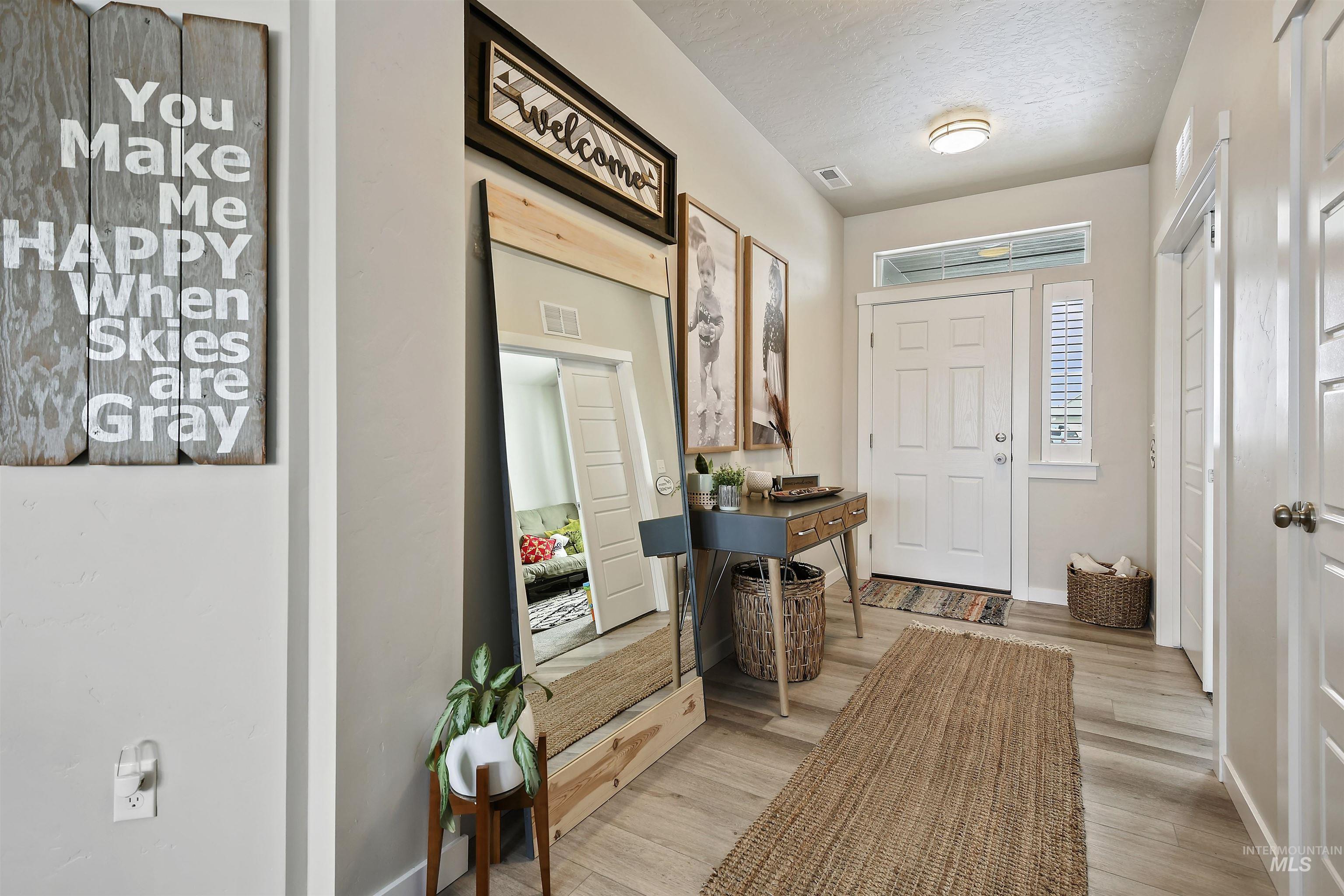 13472 Deodar Street Caldwell, ID 83607 - Photo 2 of 22 Foyer entrance with light wood-style flooring and a textured ceiling
