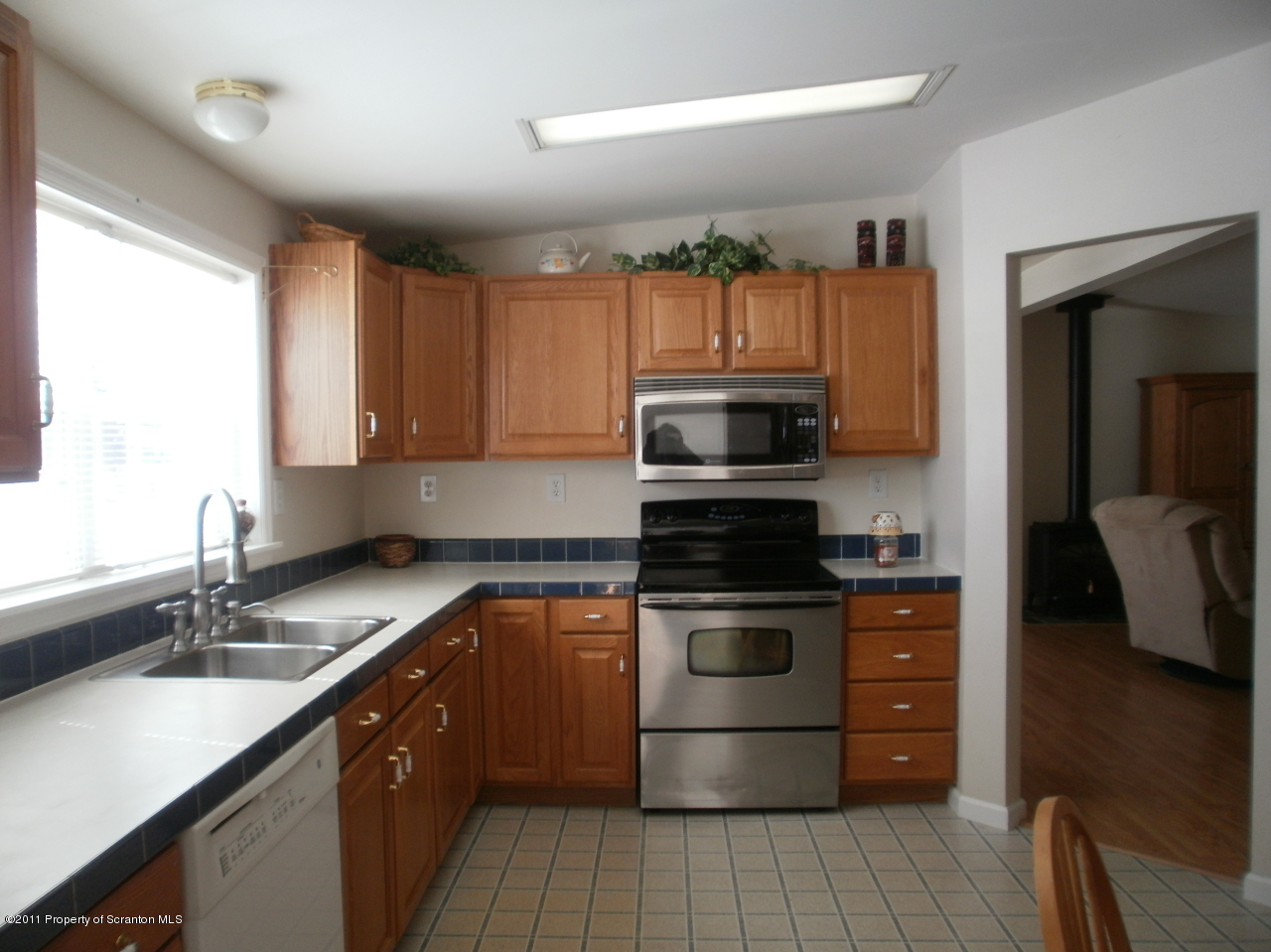 340 Aberdeen Road Moscow, PA 18444 - Photo 29 of 32 a kitchen with granite countertop a sink a stove top oven and cabinetry