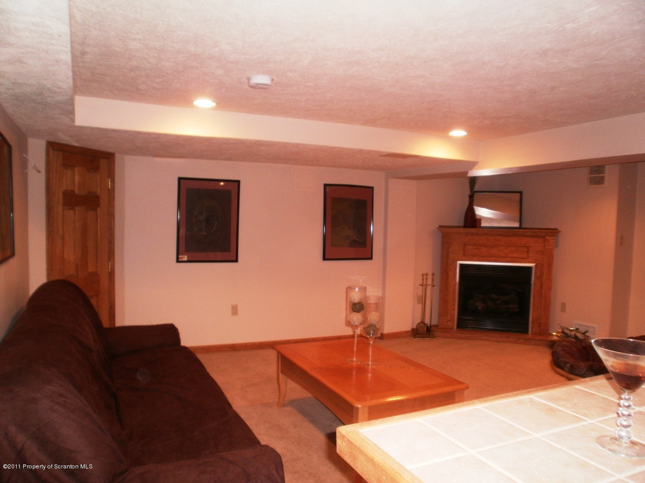 340 Aberdeen Road Moscow, PA 18444 - Photo 7 of 32 a living room with furniture a fireplace and a flat screen tv