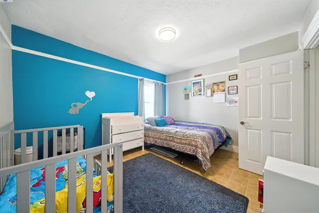 a bedroom with furniture and a baby crib