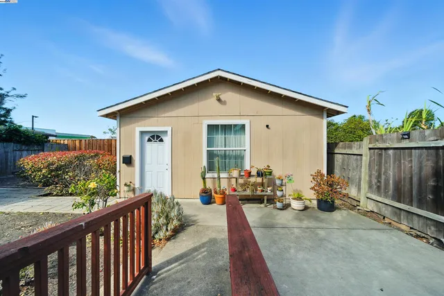 a view of a house with backyard sitting area and garden