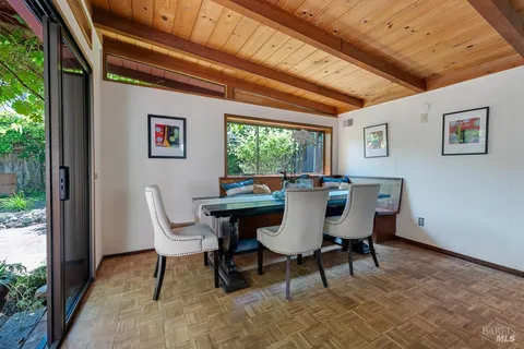 a view of a dining room with furniture window and outside view