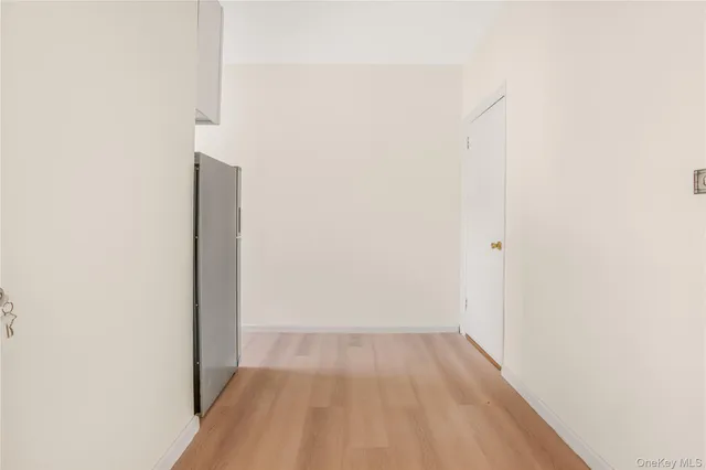 a view of storage and utility room with wooden floor