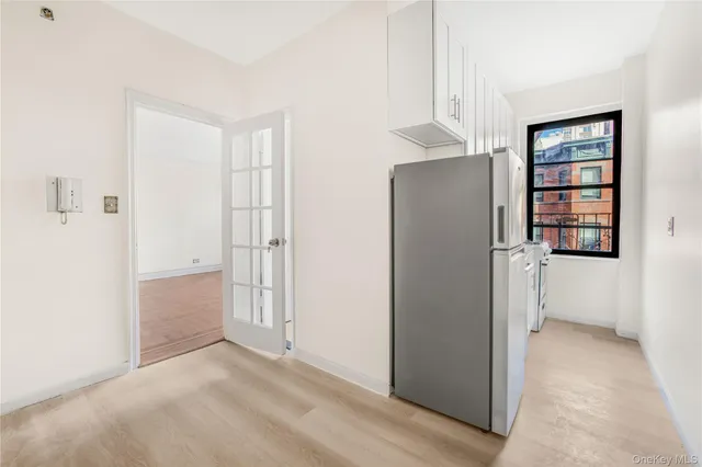 an empty room with windows and closet