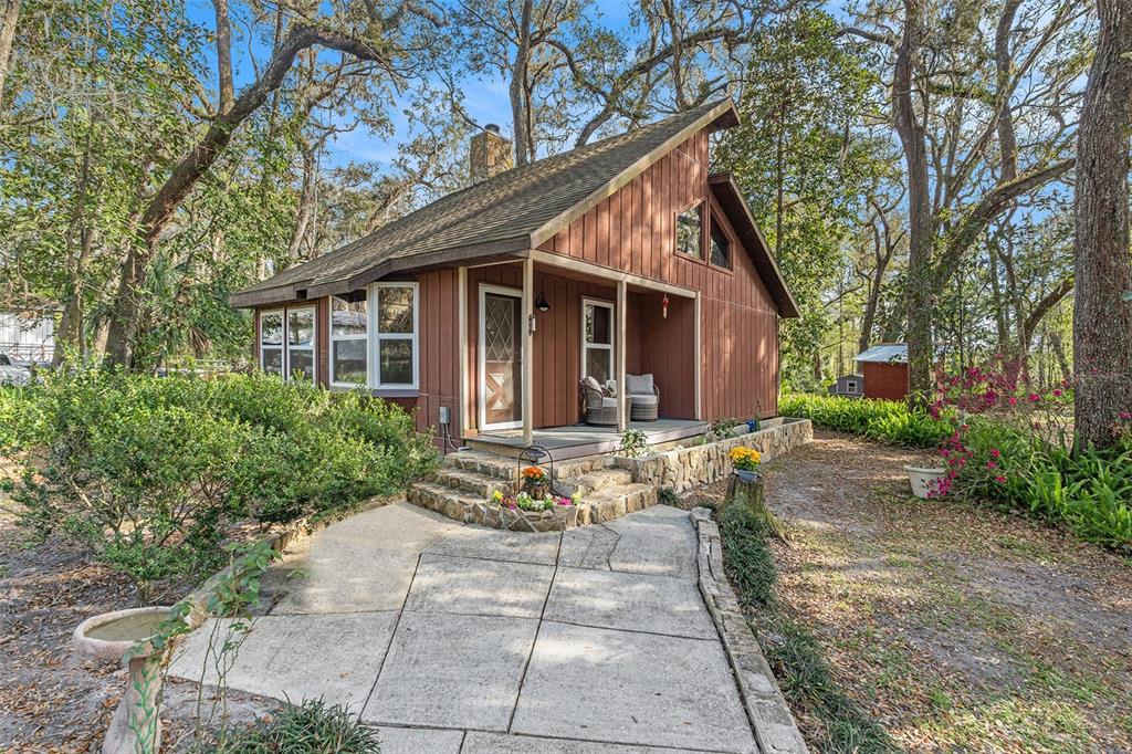 a view of a house with backyard and sitting area