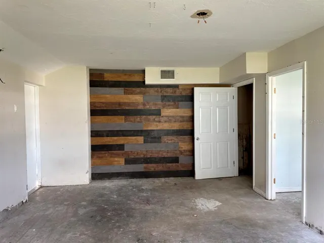 a view of an empty room and fire place