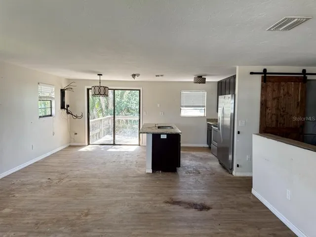 a view of a kitchen with wooden floor and kitchen space
