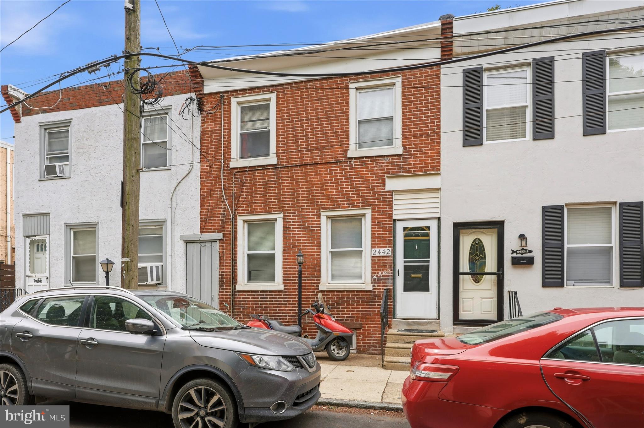 2442 East Gordon Street Philadelphia, PA 19125 - Photo 13 of 40 a front view of a house with parking space