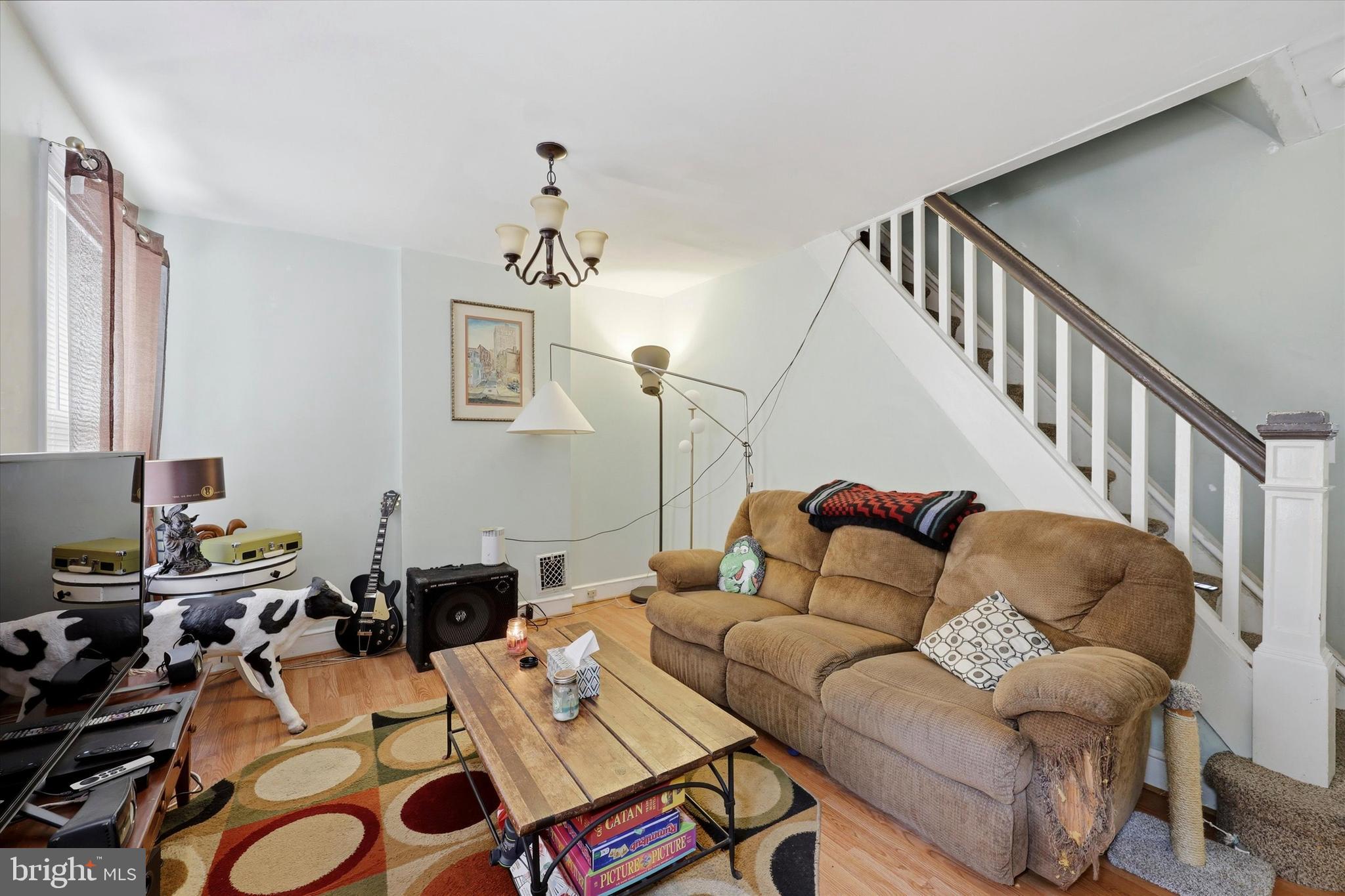 2442 East Gordon Street Philadelphia, PA 19125 - Photo 14 of 40 a living room with furniture a wooden floor and a chandelier