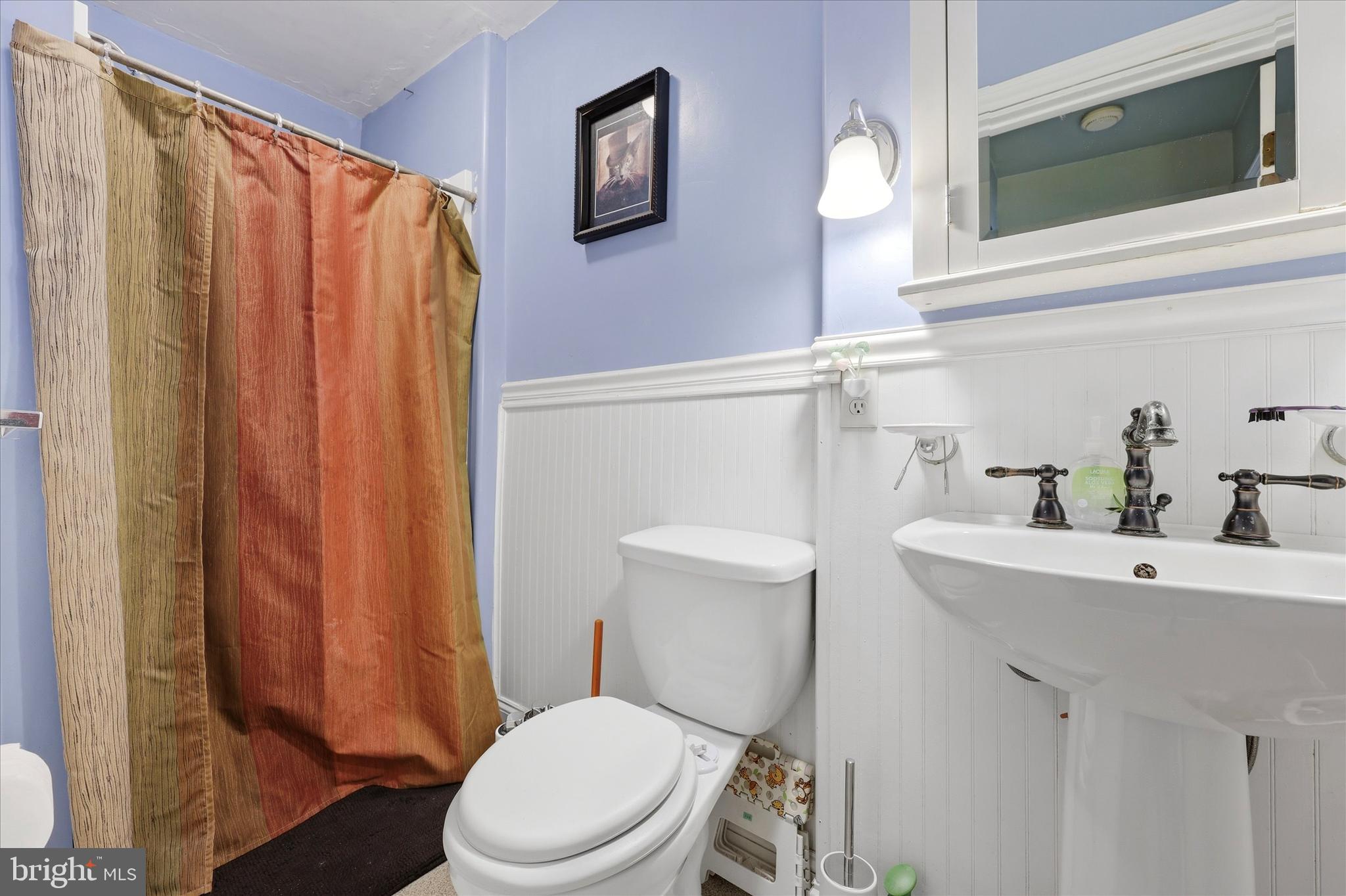 2442 East Gordon Street Philadelphia, PA 19125 - Photo 24 of 40 a white toilet sitting next to a bathroom sink