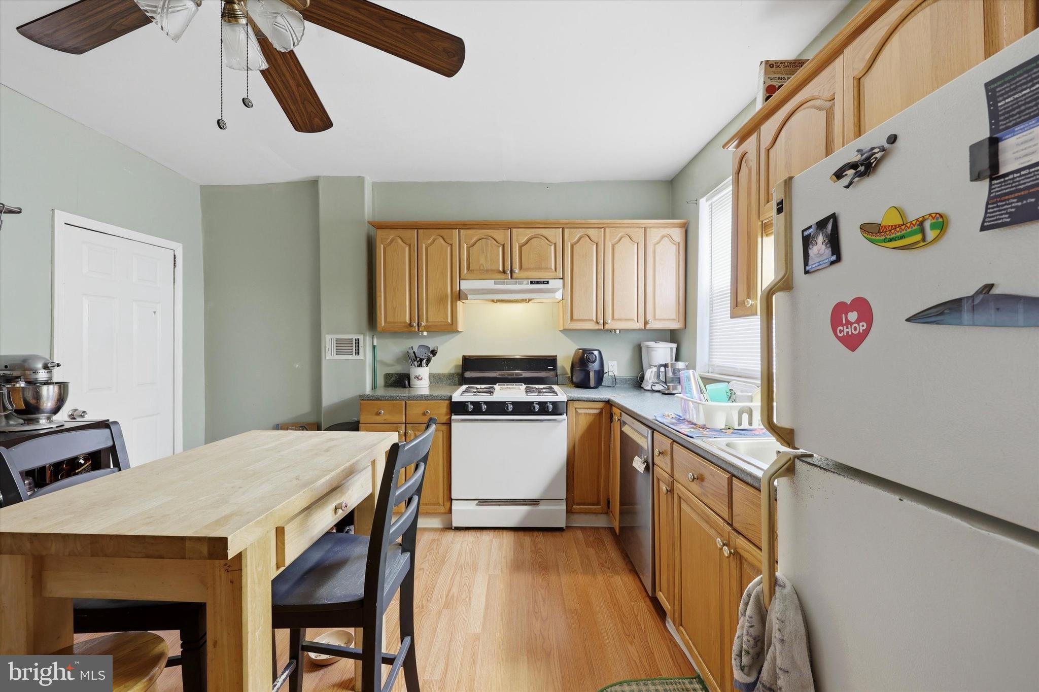 2442 East Gordon Street Philadelphia, PA 19125 - Photo 5 of 40 a kitchen with a stove a sink a refrigerator and a table