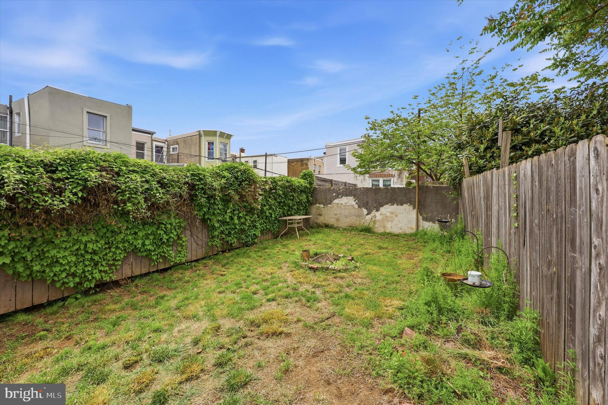 2442 East Gordon Street Philadelphia, PA 19125 - Photo 10 of 40 a backyard of a house with plants and large trees