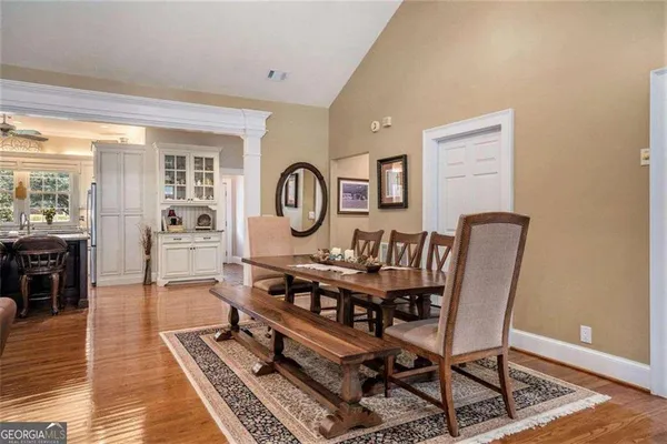 a living room with furniture a chandelier and a large window