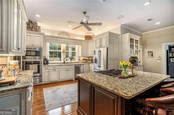 a spacious bathroom with a granite countertop sink and a mirror