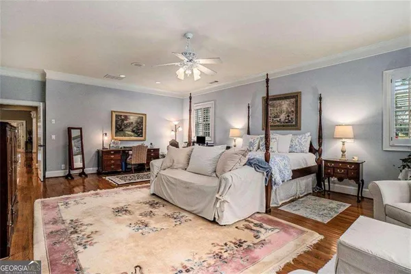 a view of a house with a yard and a large tree