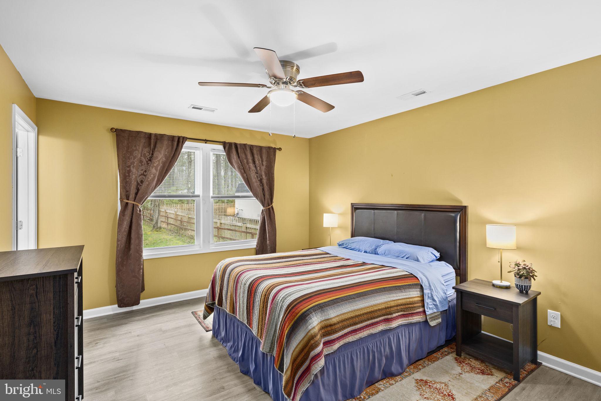 84 Pinewood Lane Colonial Beach, VA 22443 - Photo 16 of 38 Primary bedroom with ceiling fan light fixture