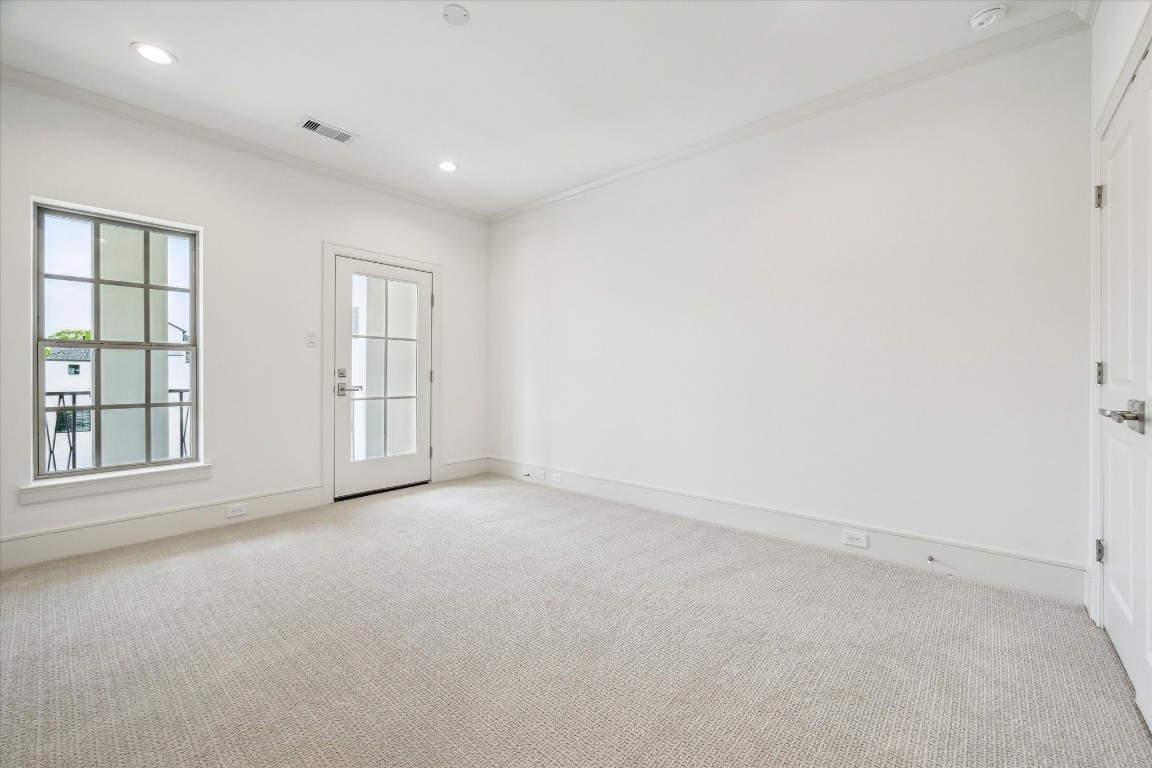 209 Sutton Row Place Houston, TX 77024 - Photo 16 of 23 Third-floor Secondary Bedroom with walk-in closet, and glass door for access to balcony.