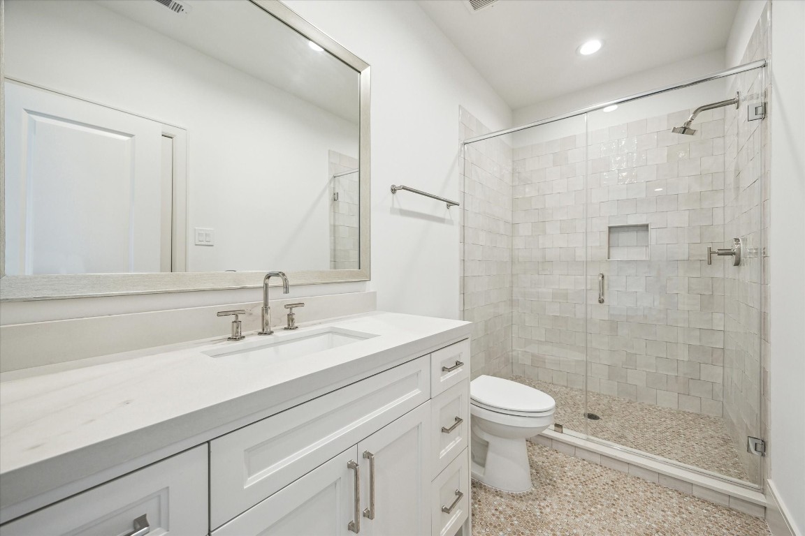 209 Sutton Row Place Houston, TX 77024 - Photo 17 of 23 Full bath accessible to game room and secondary bedroom, with glass enclosed shower.