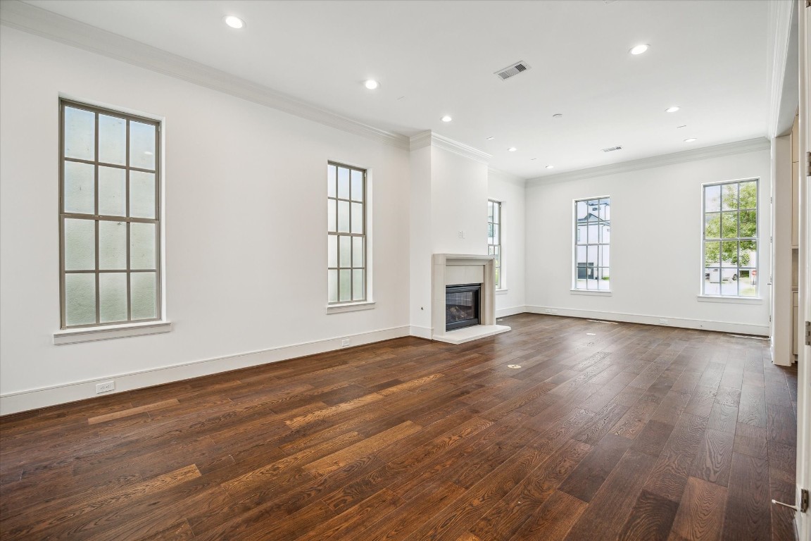 209 Sutton Row Place Houston, TX 77024 - Photo 3 of 23 Living Room features cast stone fireplace and wonderful natural light from ample windows.