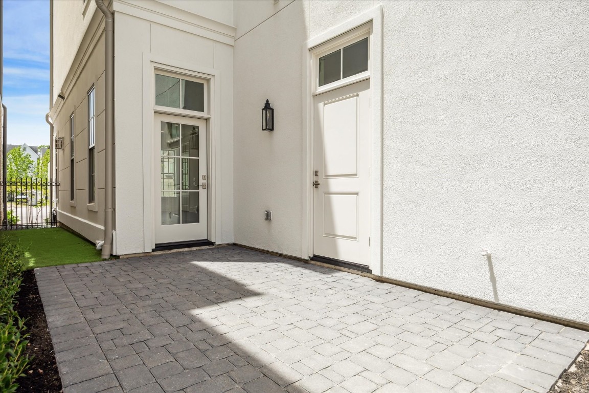 209 Sutton Row Place Houston, TX 77024 - Photo 7 of 23 Private courtyard features patio and artificial turf, accessible from glass door in house, side door to garage and back gate from curb.