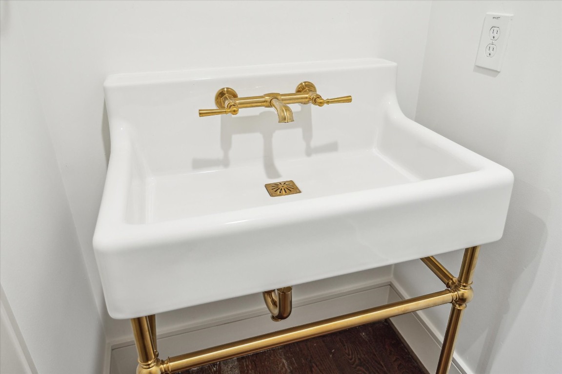 209 Sutton Row Place Houston, TX 77024 - Photo 8 of 23 Powder Bath features console sink with brass details.
