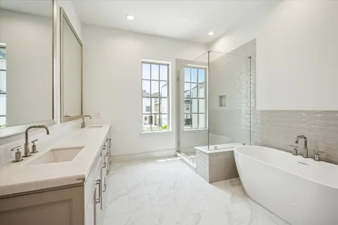 a bathroom with a tub sink and mirror
