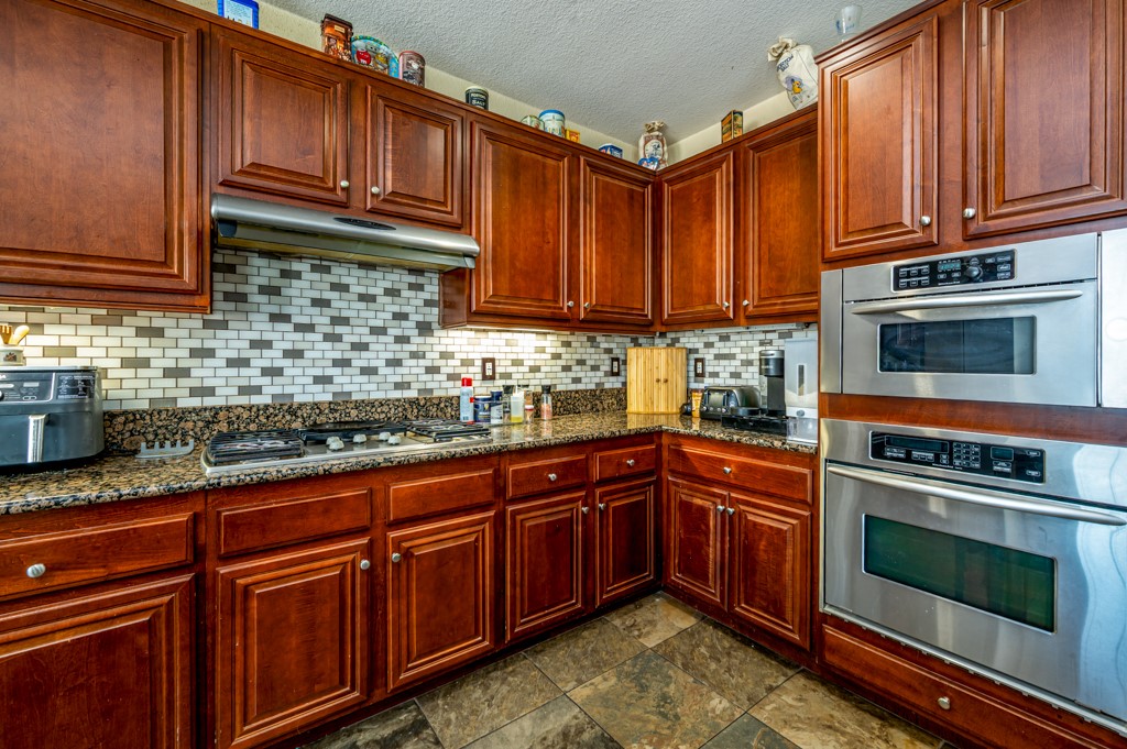 18668 Alderbrook Drive Riverside, CA 92508 - Photo 12 of 28 a kitchen with granite countertop cabinets stainless steel appliances and a counter space