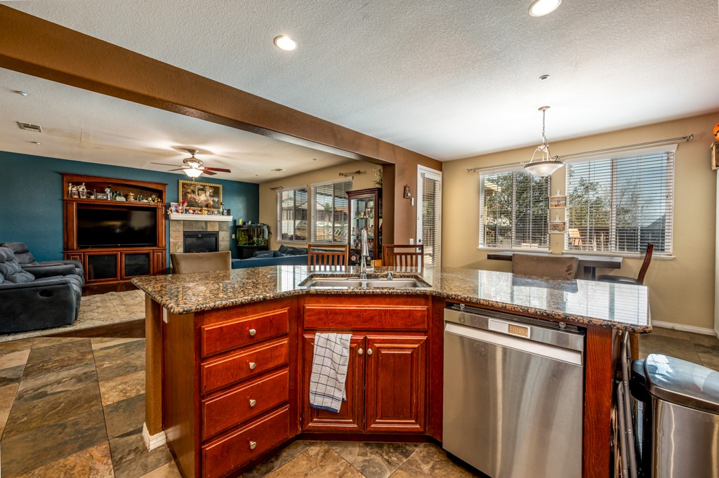 18668 Alderbrook Drive Riverside, CA 92508 - Photo 14 of 28 a kitchen with stainless steel appliances granite countertop a stove a sink and a refrigerator