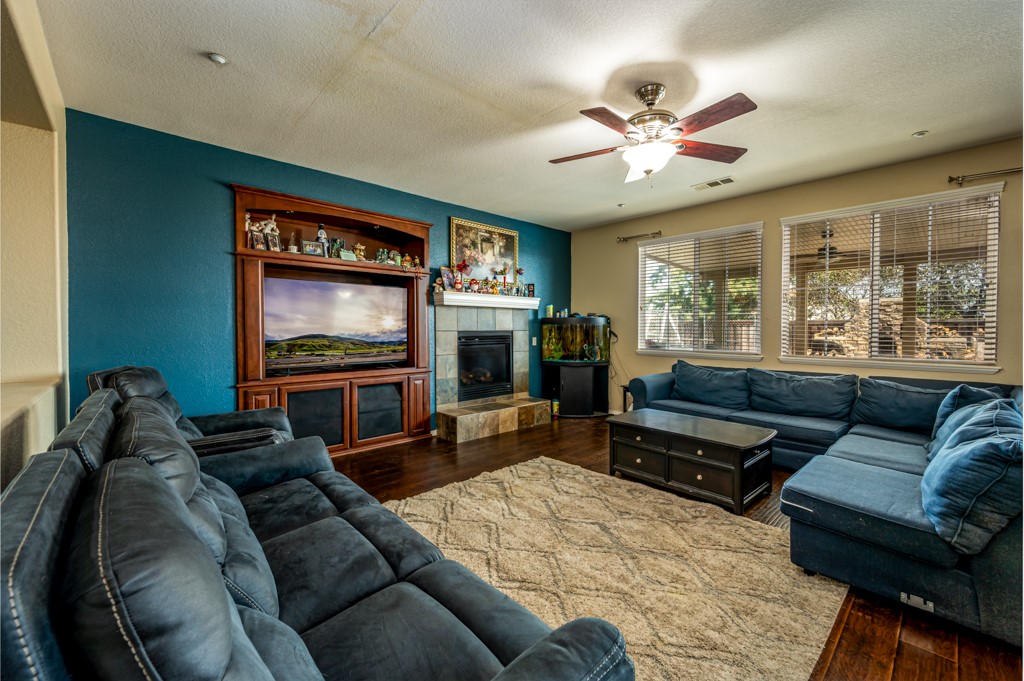 18668 Alderbrook Drive Riverside, CA 92508 - Photo 8 of 28 a living room with furniture and a flat screen tv with wooden floor