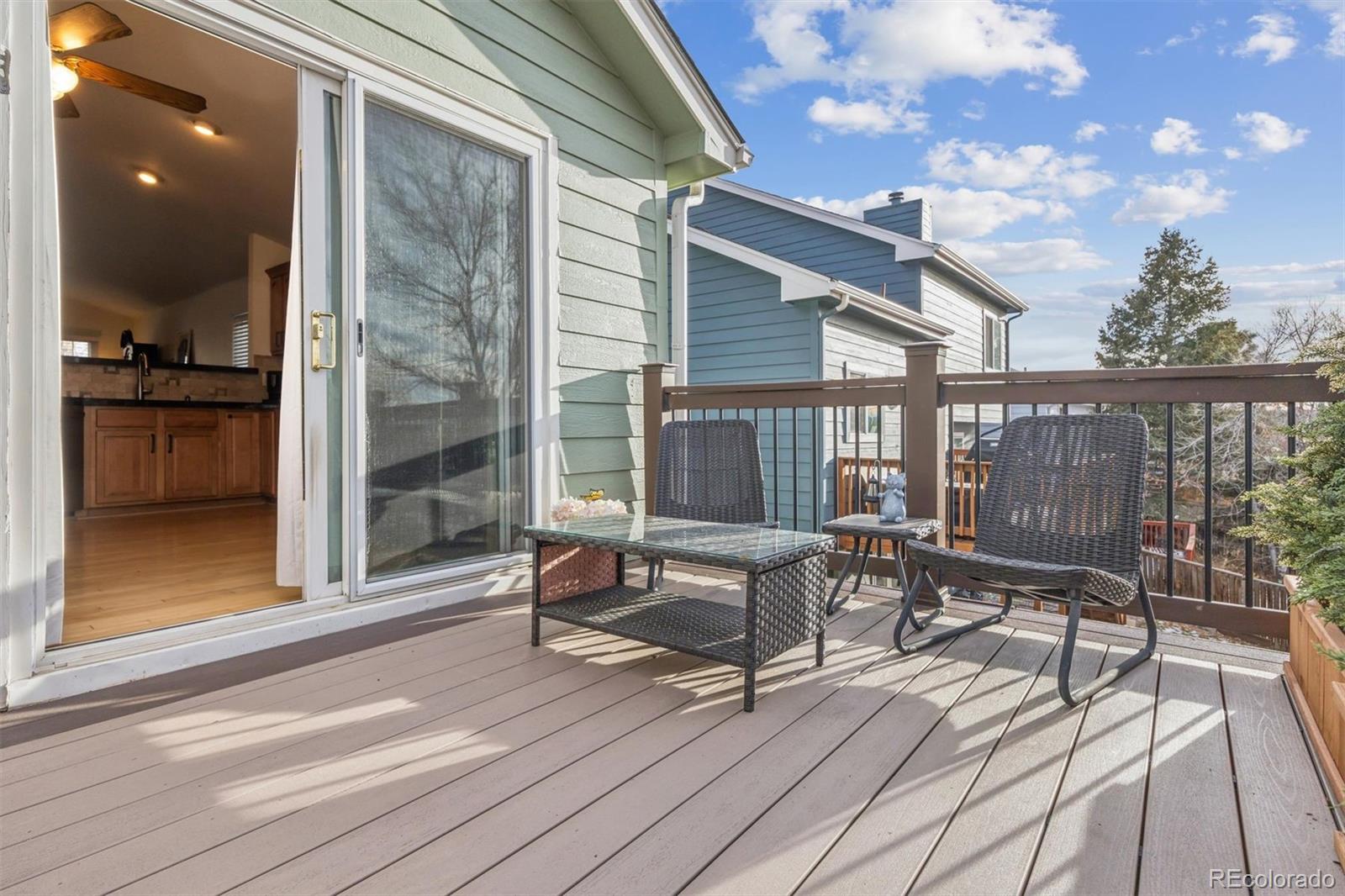 9471 Burlington Lane Highlands Ranch, CO 80130 - Photo 15 of 50 a view of balcony with wooden floor and outdoor seating