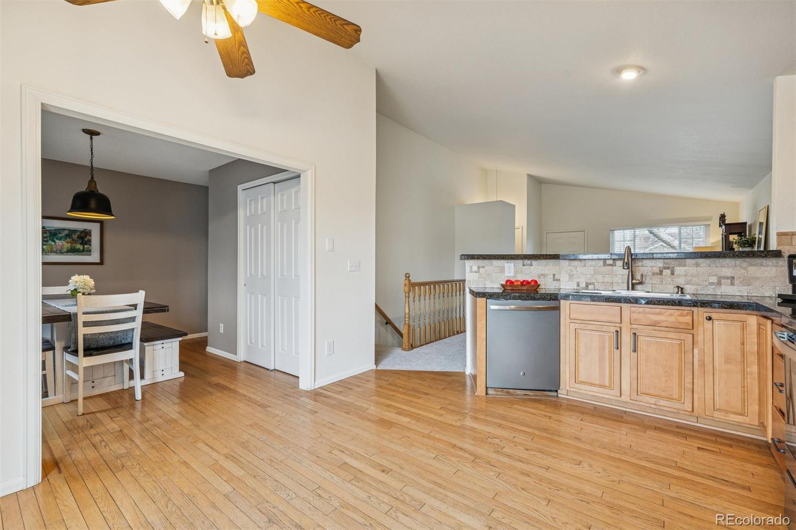 9471 Burlington Lane Highlands Ranch, CO 80130 - Photo 18 of 50 a kitchen with a sink cabinets and wooden floor