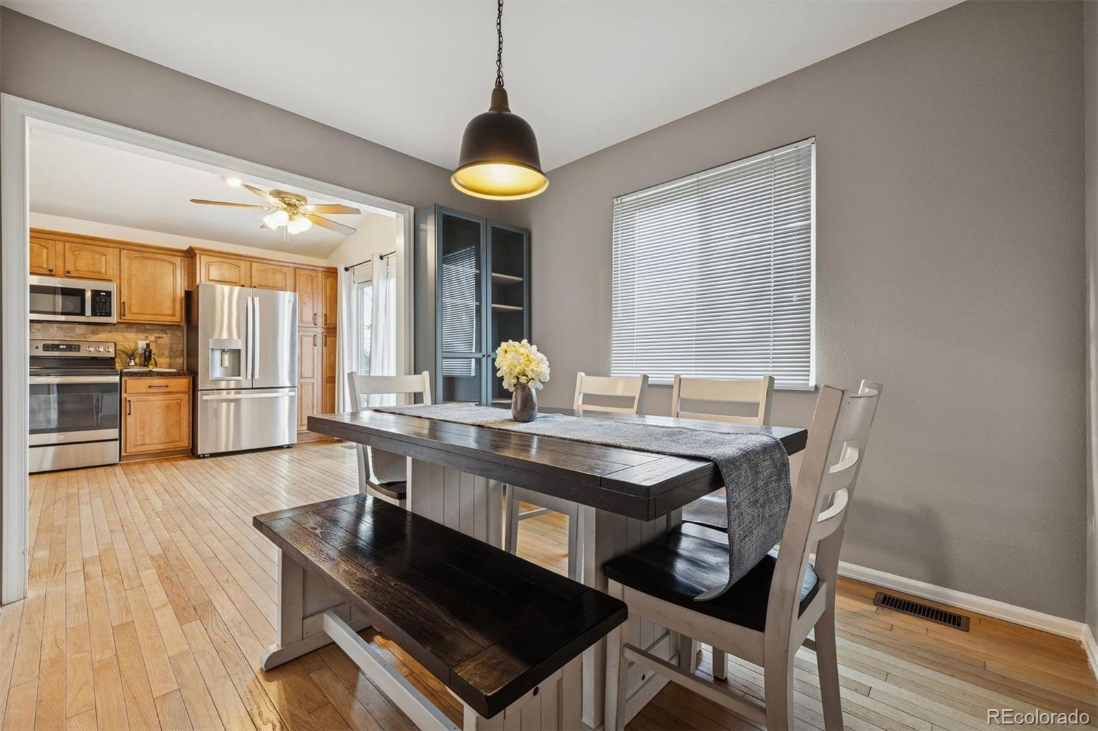 9471 Burlington Lane Highlands Ranch, CO 80130 - Photo 19 of 50 a dining room with furniture and wooden floor