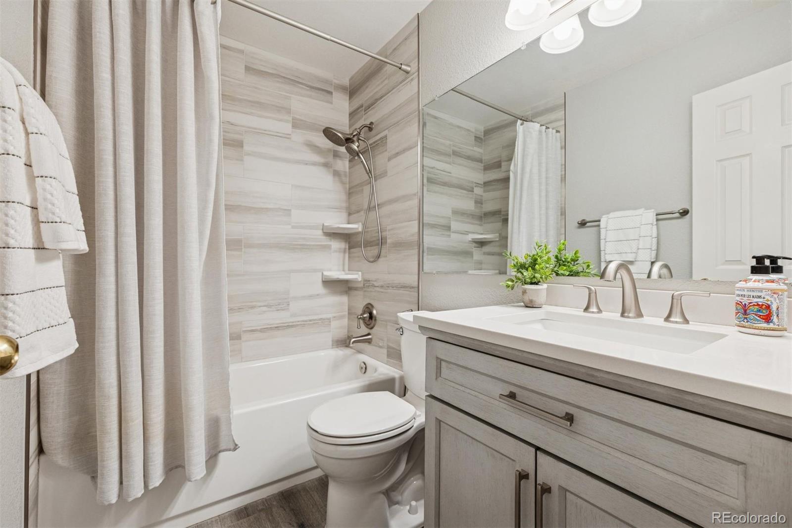 9471 Burlington Lane Highlands Ranch, CO 80130 - Photo 25 of 50 a bathroom with a sink a toilet and shower