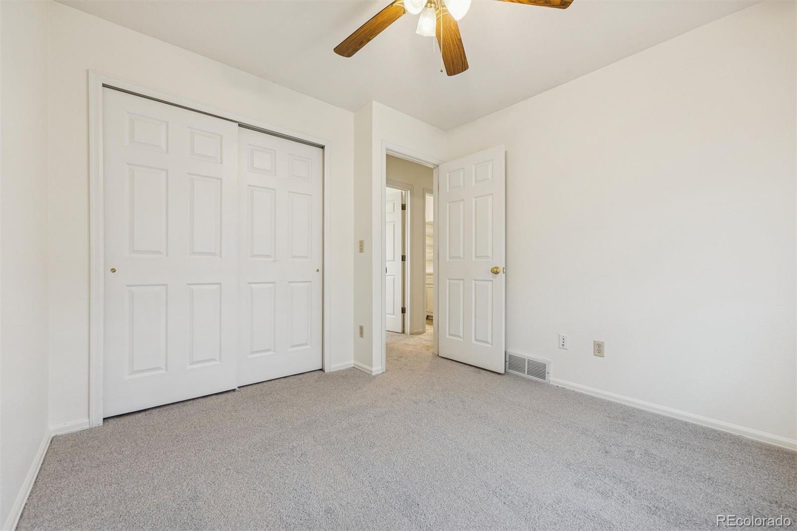 9471 Burlington Lane Highlands Ranch, CO 80130 - Photo 27 of 50 an empty room with chandelier fan