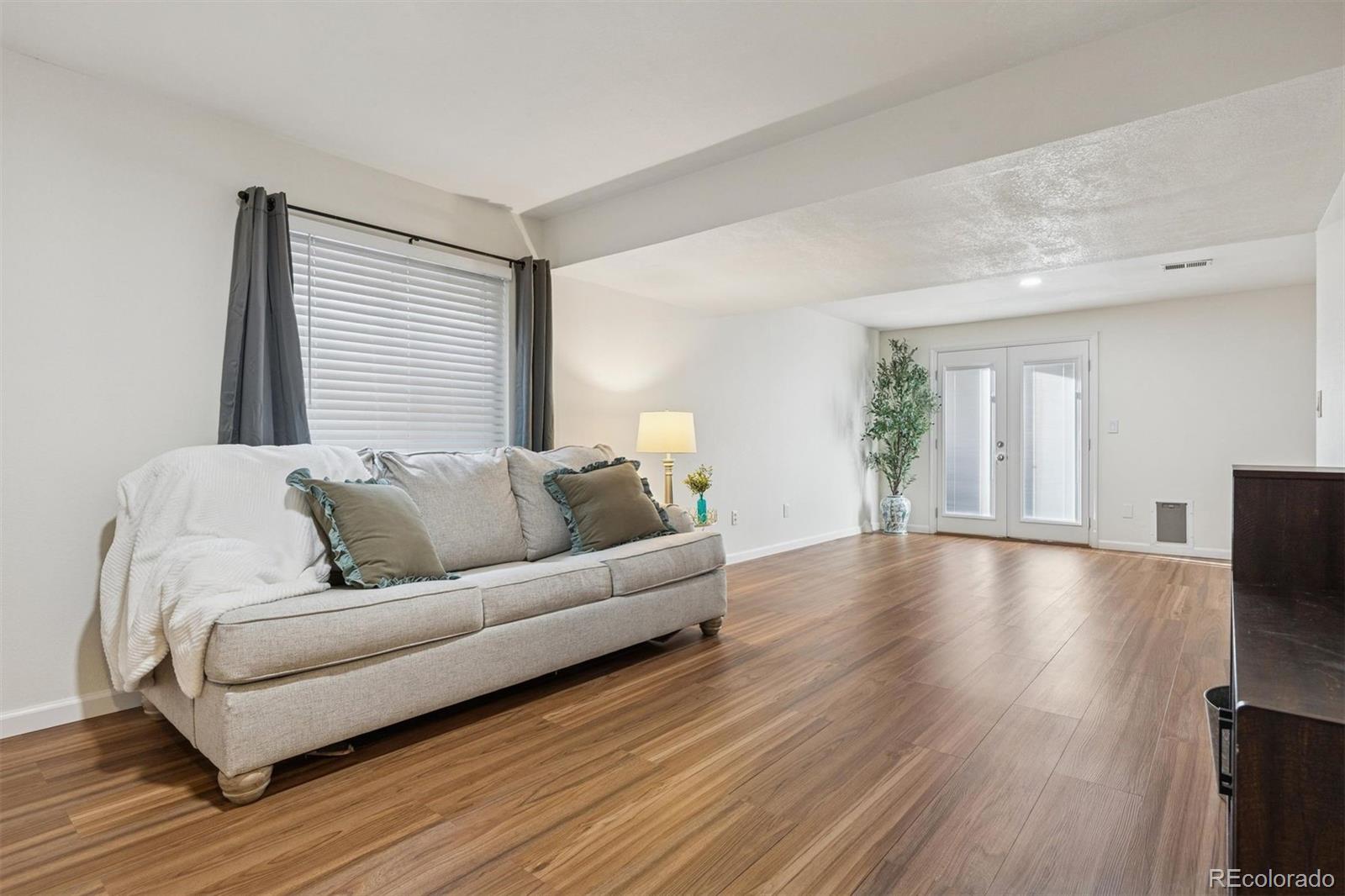 9471 Burlington Lane Highlands Ranch, CO 80130 - Photo 30 of 50 a living room with furniture and a flat screen tv